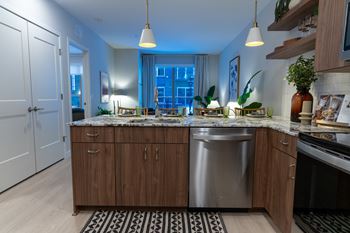 A kitchen with wooden cabinets and a stainless steel sink.